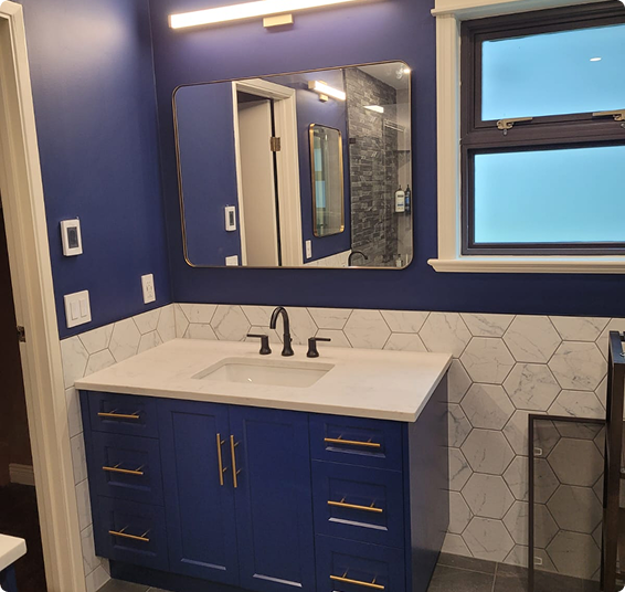 Bathroom remodel with navy vanity and hexagon tile
