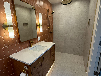 Bathroom with tile flooring, walk-in shower, and wood vanity
