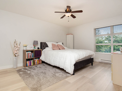 Bright bedroom with white bedding and large windows