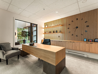 Home office with wood desk and built-in wall shelving