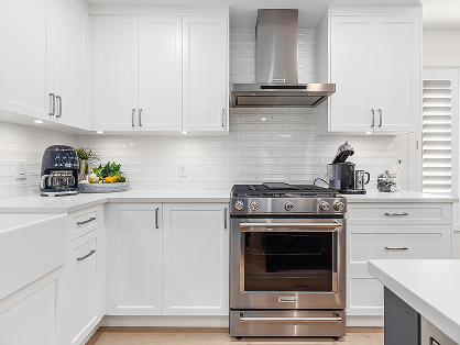 Renovated white kitchen with stainless steel appliances